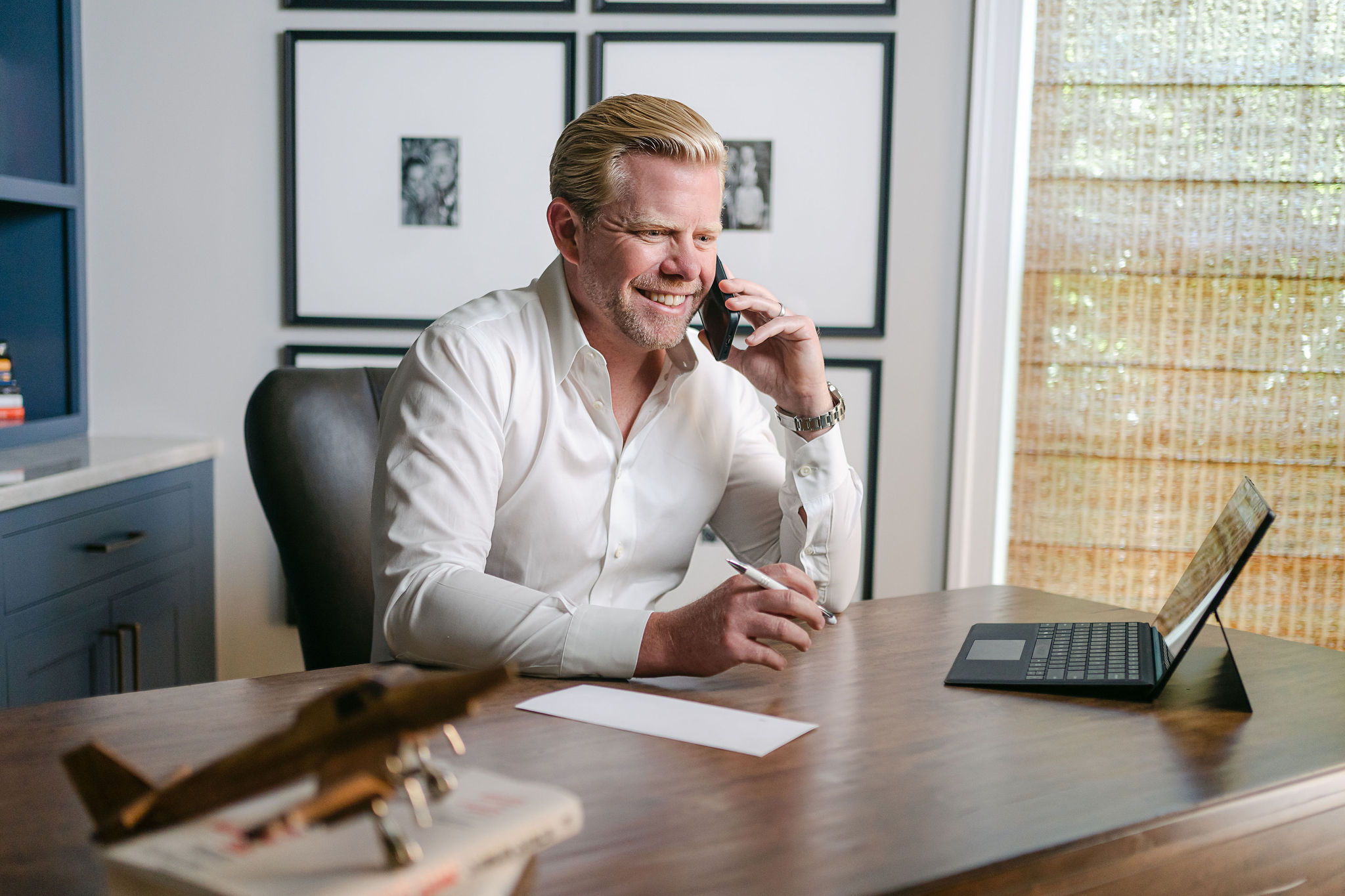 Man at desk talking on his cell phone